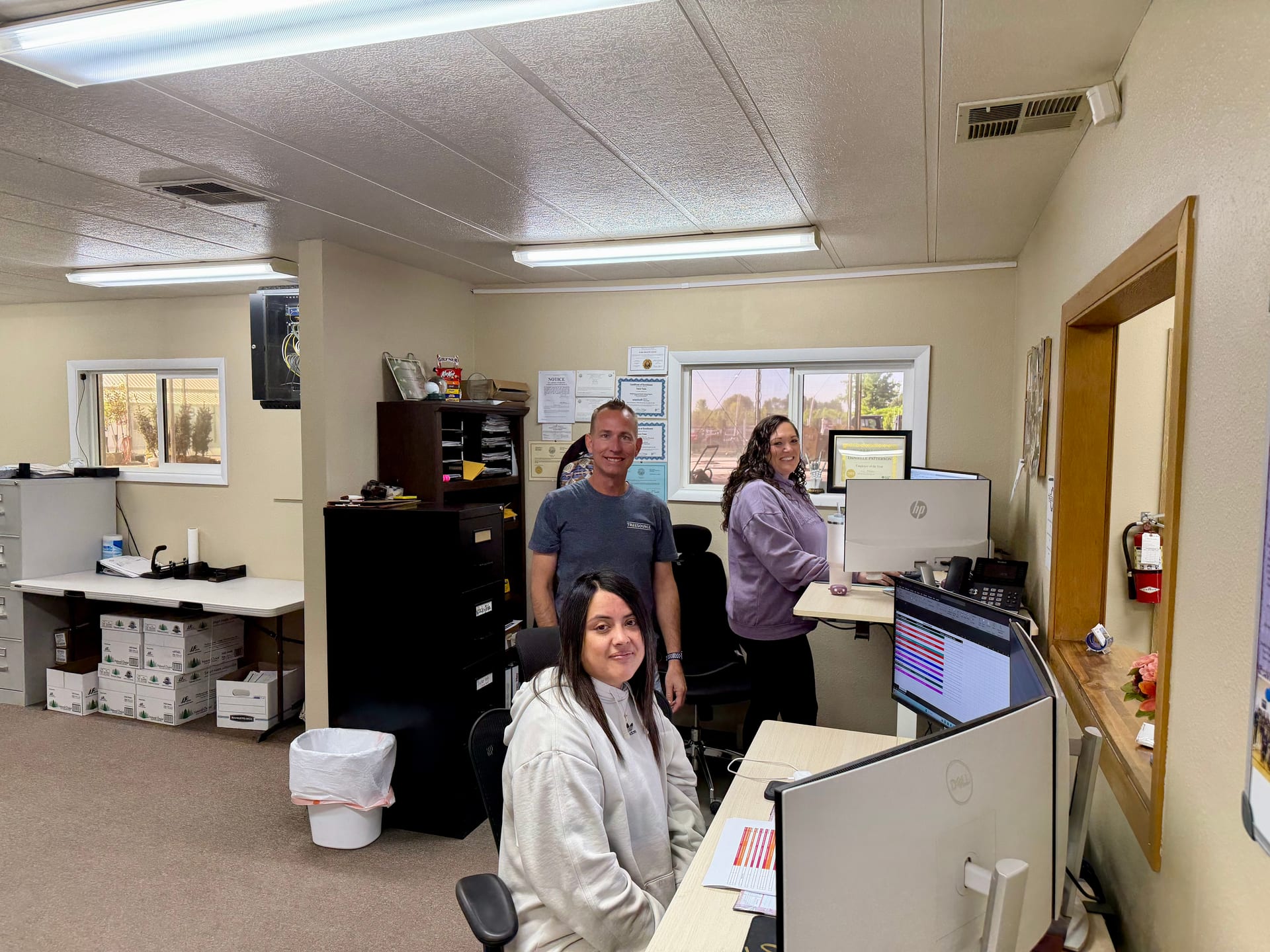 Smiling Tree Source operations team members at their desks in the Rupert, Idaho farm office