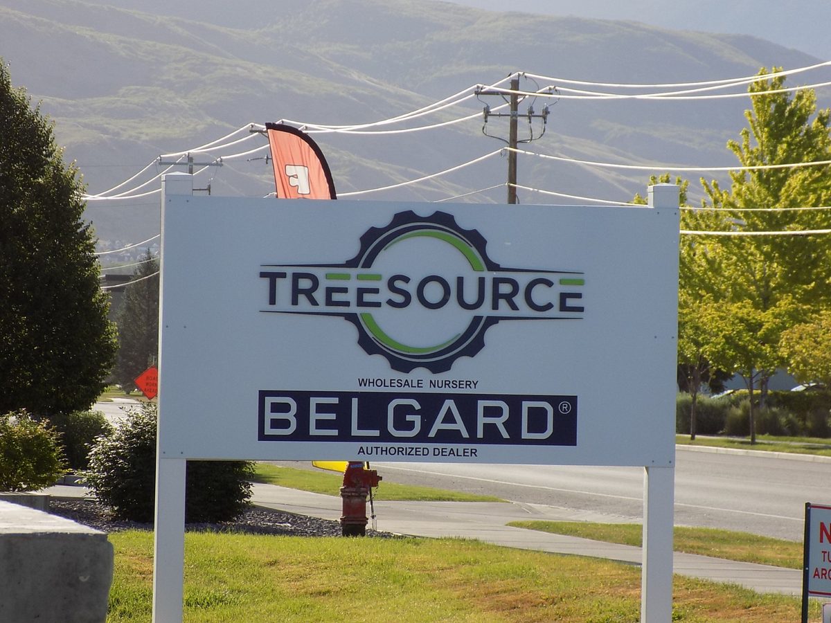Tree Source wholesale nursery and Belgard authorized dealer sign with the Wasatch mountains behind